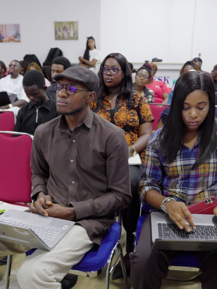 Audience members with laptops